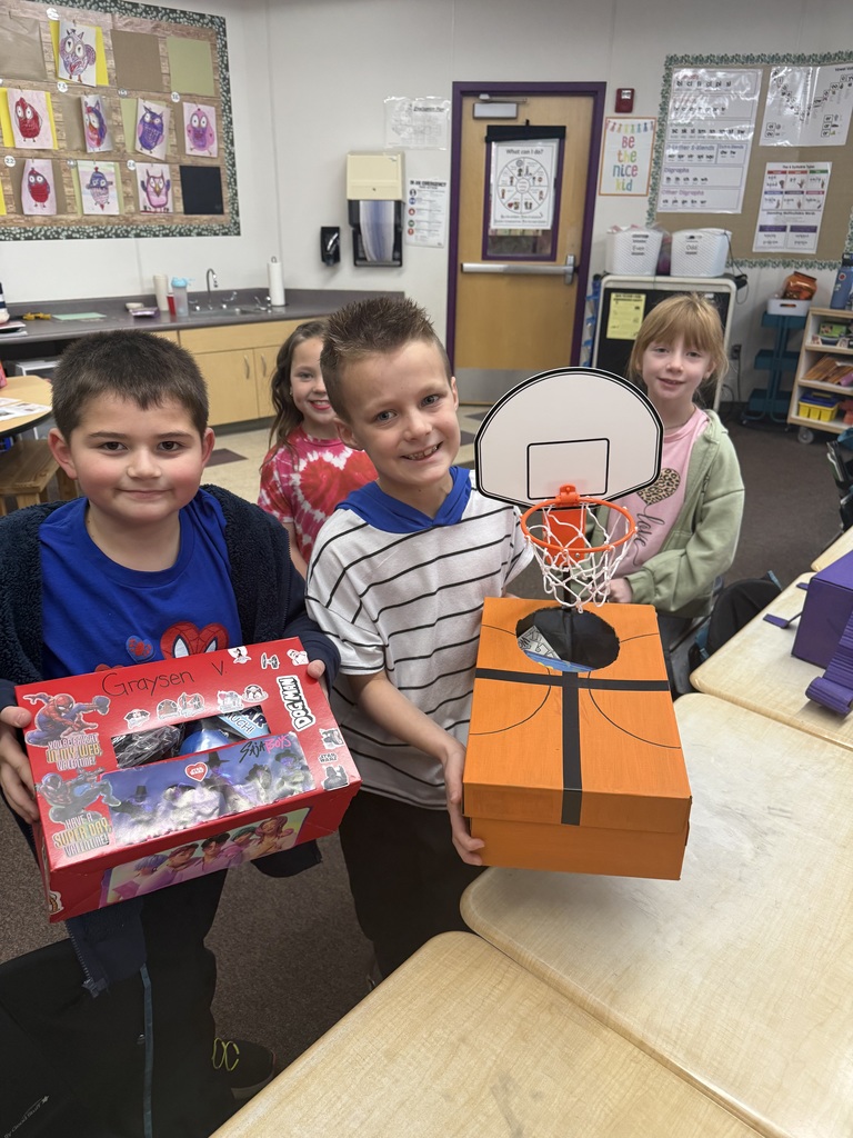 students smiling with valentine boxes