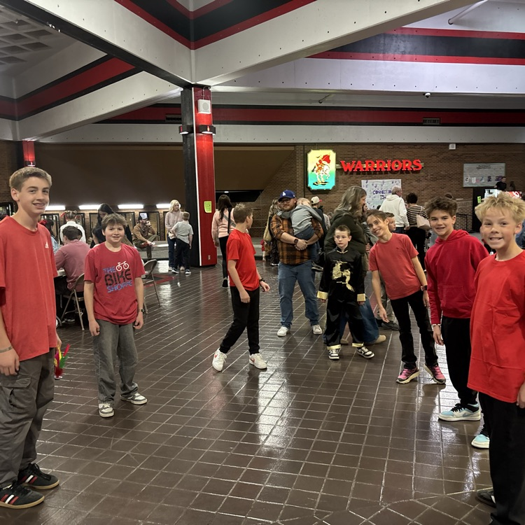 students of Bates Elementary in red shirts and black pants posing for a picture during the culture activities 