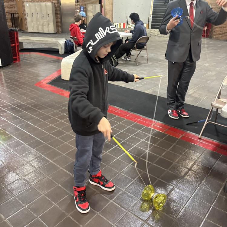 a student of bates elementary trying out one of the puppet yo-yo activities at the culture activities 
