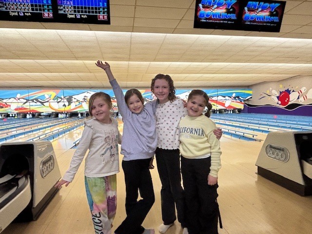 students smiling at the bowling alley