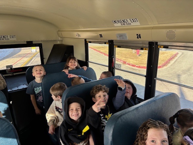 students smiling on the bus