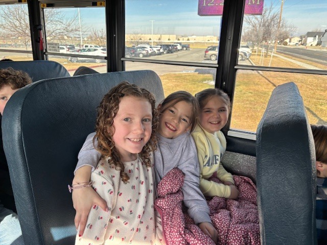 students smiling on the bus