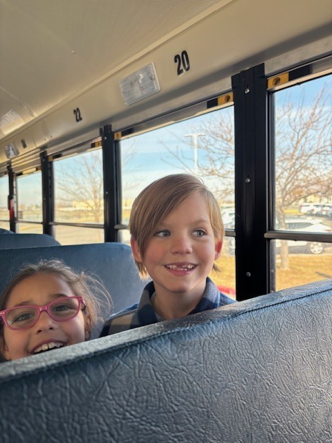 students smiling on the bus
