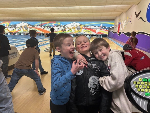 students making silly faces at the bowling alley