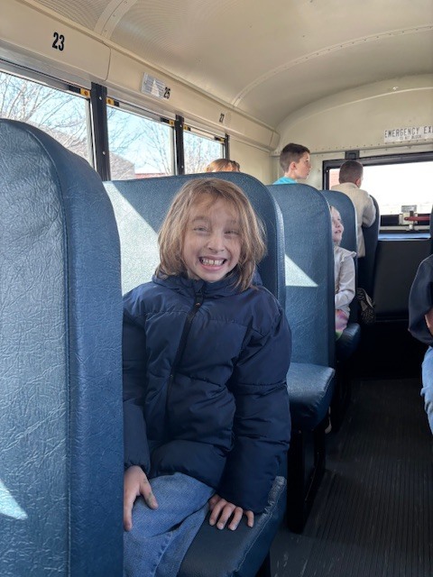 student smiling on the bus