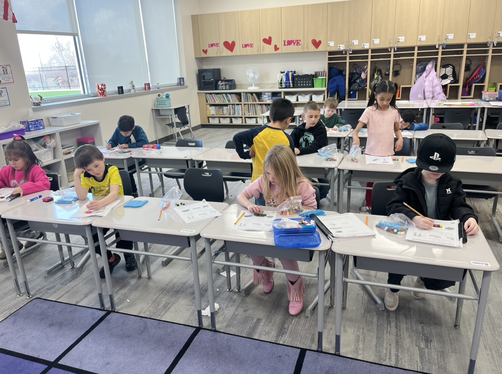 students doing math and measuring with CM cubes