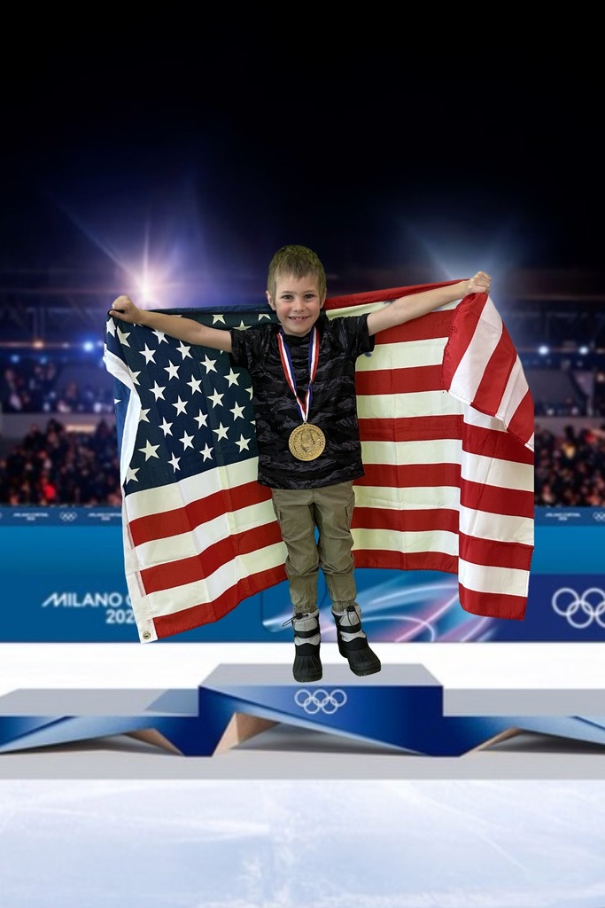 first grade student standing on an olympic podium wearing a gold medal and holding the USA Flag
