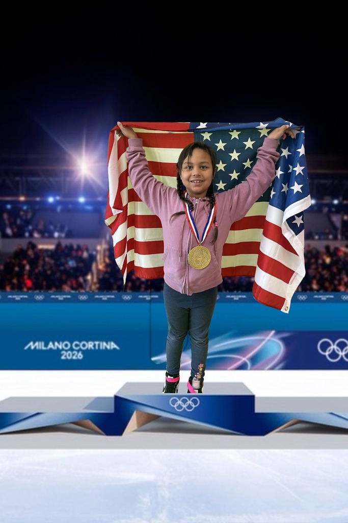first grade student standing on an olympic podium wearing a gold medal and holding the USA Flag