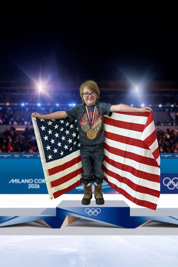 first grade student standing on an olympic podium wearing a gold medal and holding the USA Flag