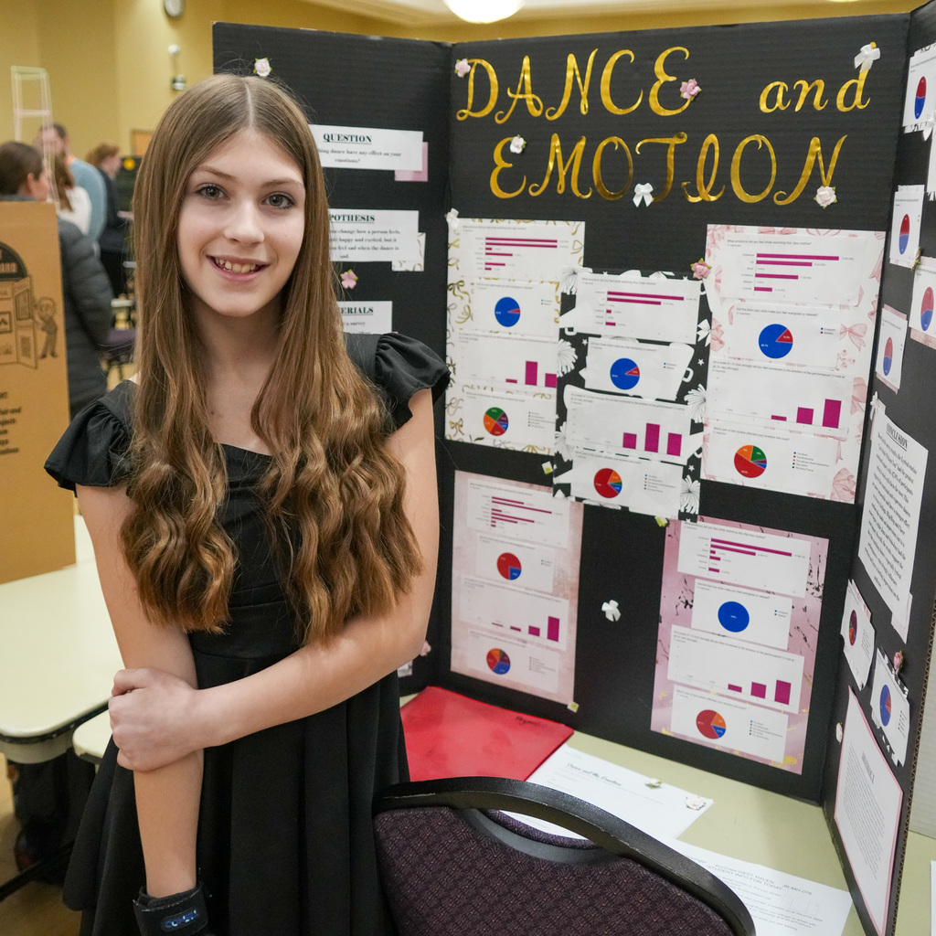Stem Fair students standing with their projects.