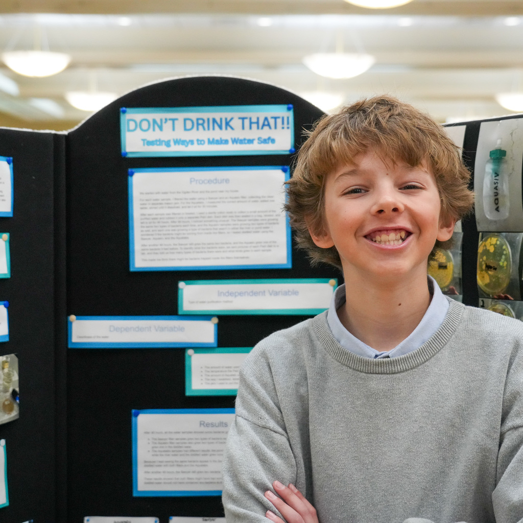 Stem Fair students standing with their projects.