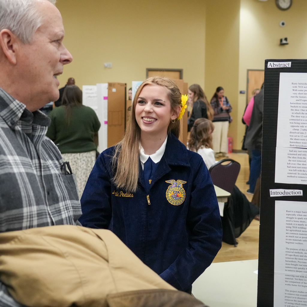 Stem Fair students standing with their projects.