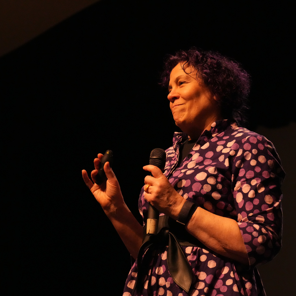 Students listening and receiving signed book from author