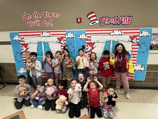 Mrs Stoker's class in front of a Dr. Seuss Banner