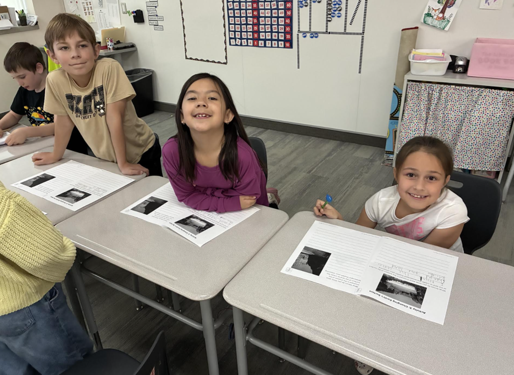 students with their science notebooks