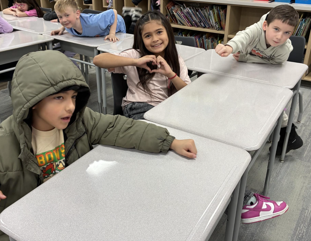 students showing the actions that go along with vocabulary words