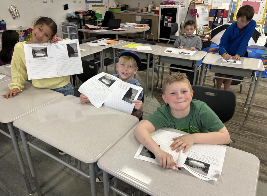 students with their science notebooks