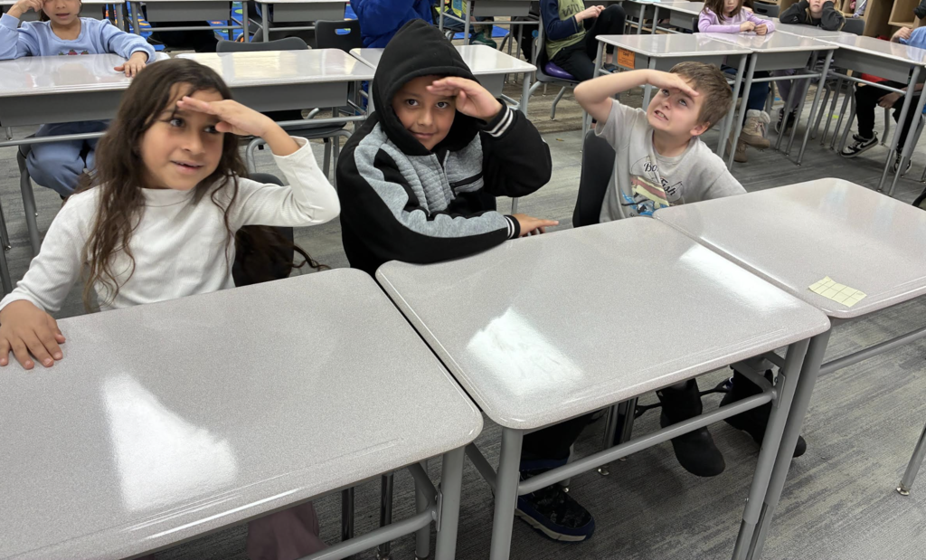 students showing the actions that go along with vocabulary words