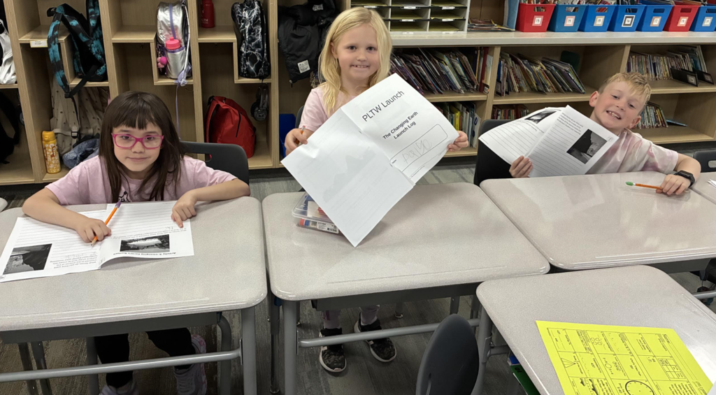 students with their science notebooks