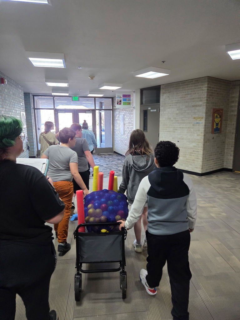 Students working together as a team to pull the wagon