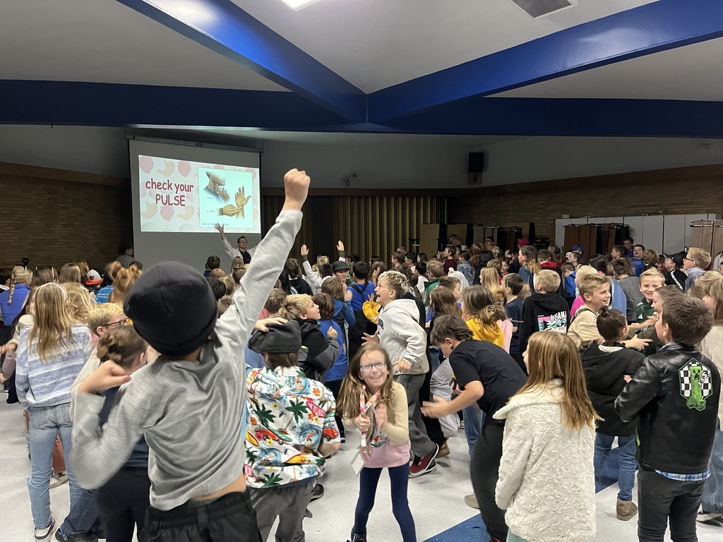 Students of Bate Elementary getting their pulse up by running in place while Dr. McCann an author visits our school.