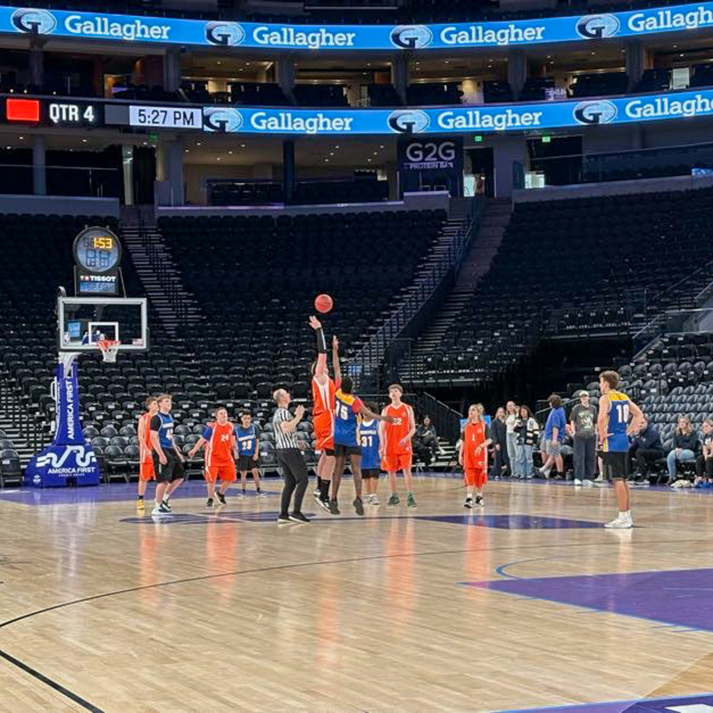 Jump ball at the start of a game in the delta center