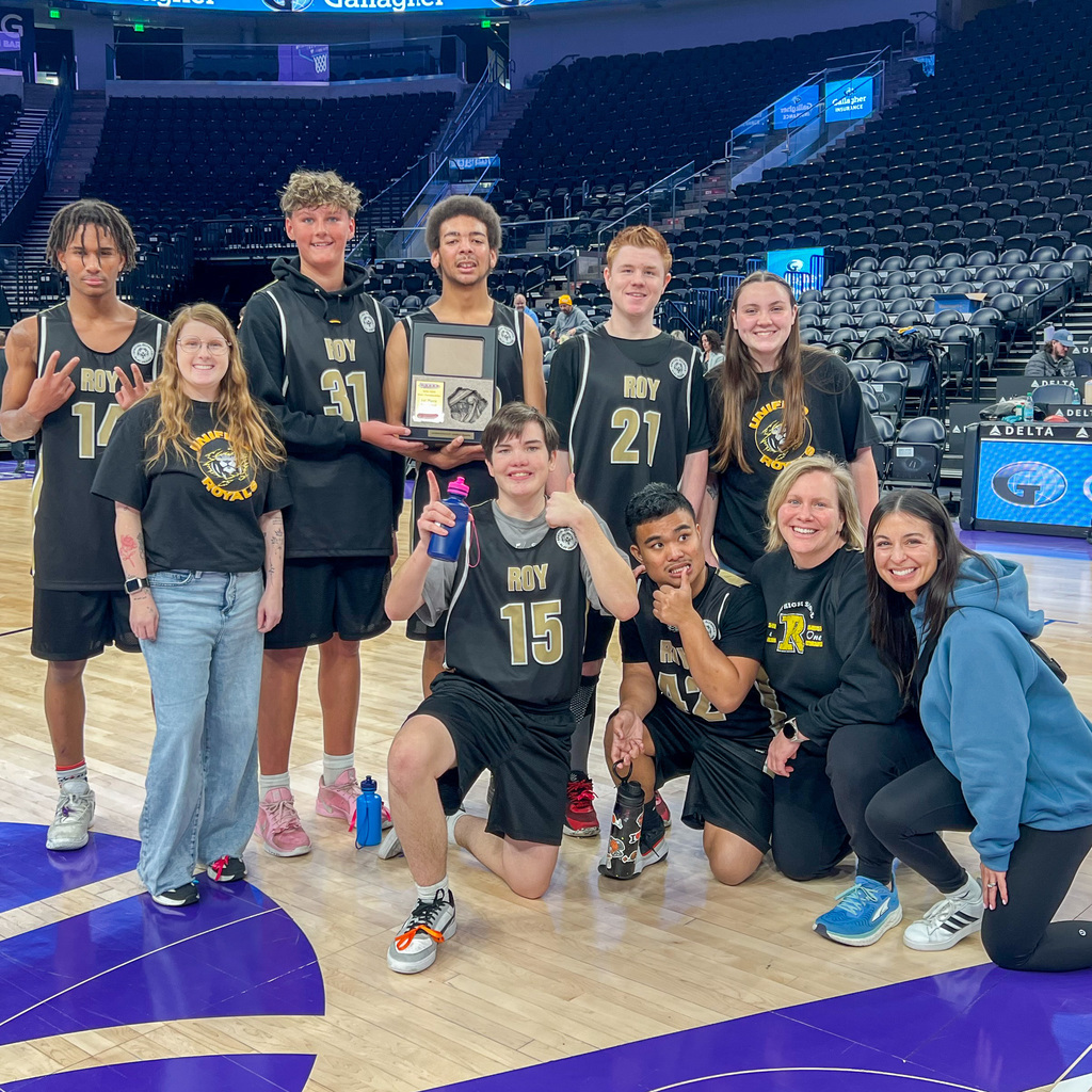 Roy High BLKxGLD Team photo on the court at the Delta Center