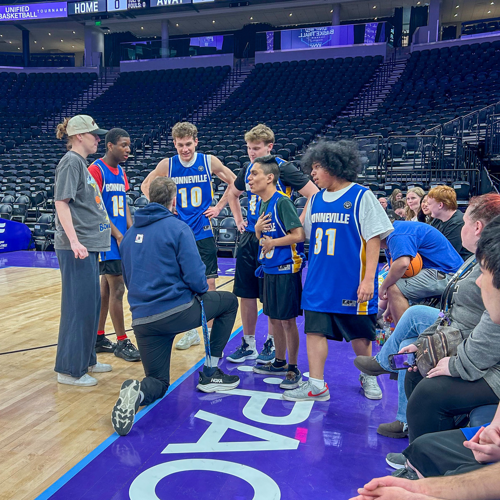 Coaches talking to the team courtside