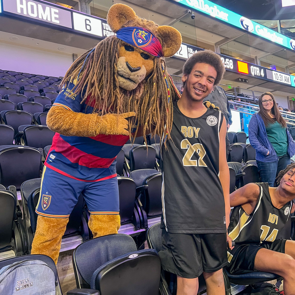 Player posing with the Real Soccer Mascot in costume