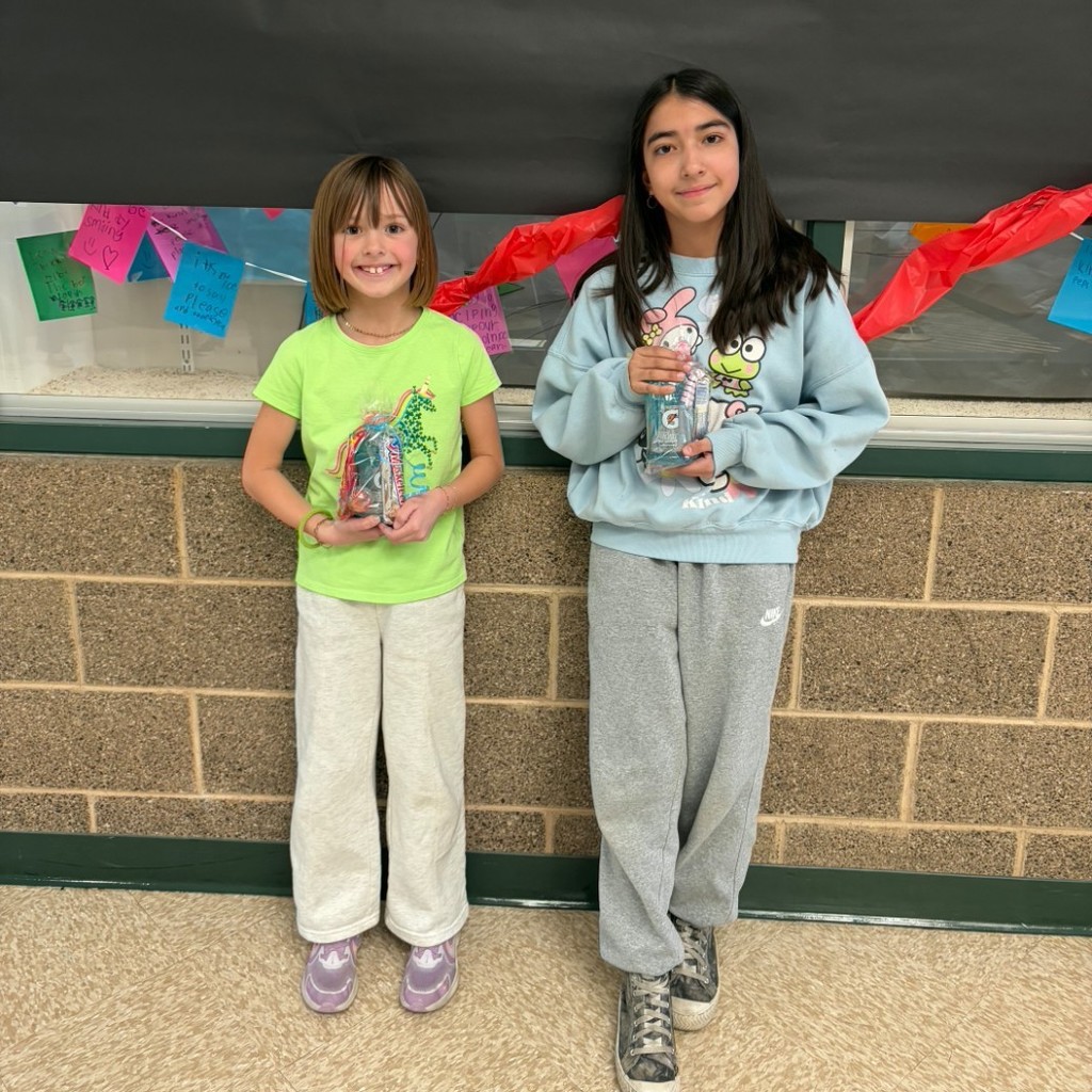 two girls holding certificates