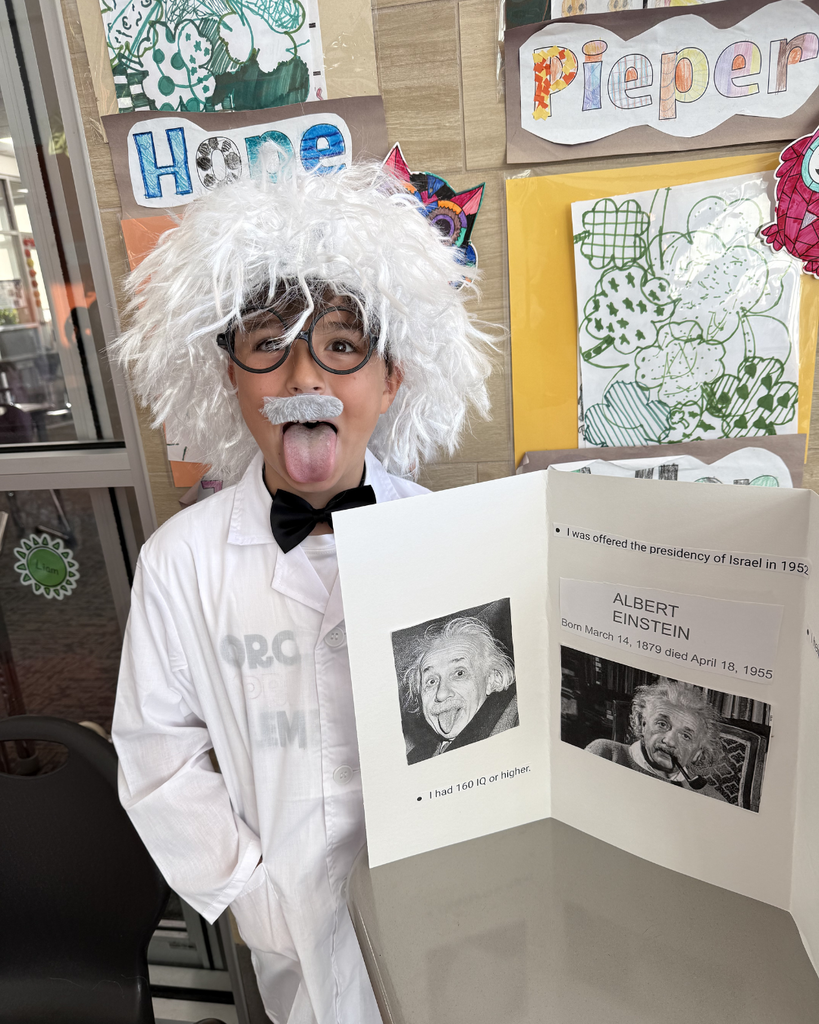 Student dressed up as Albert Einstein, white hair, glasses with fun expression. 