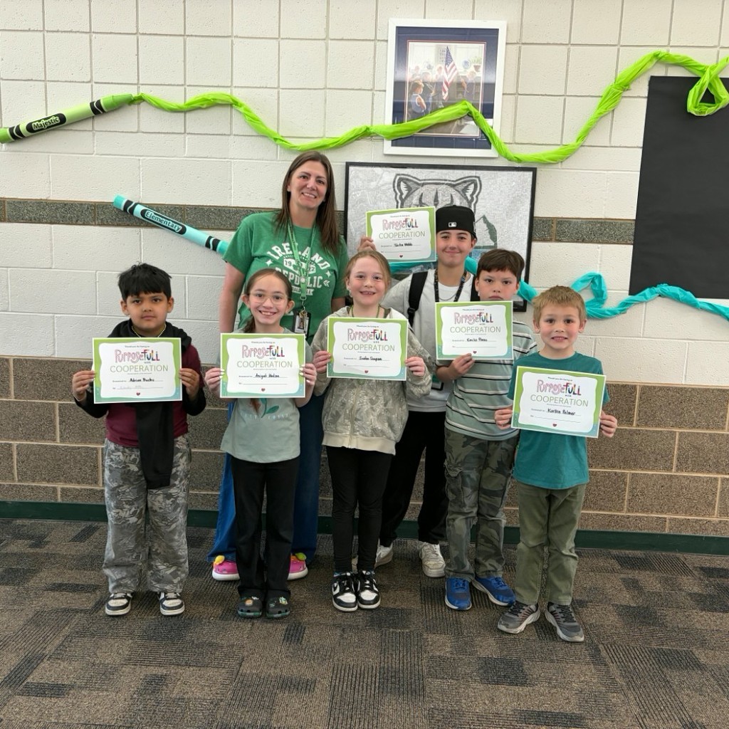 Mrs. Jacobsen with the students of the month holding certificates.