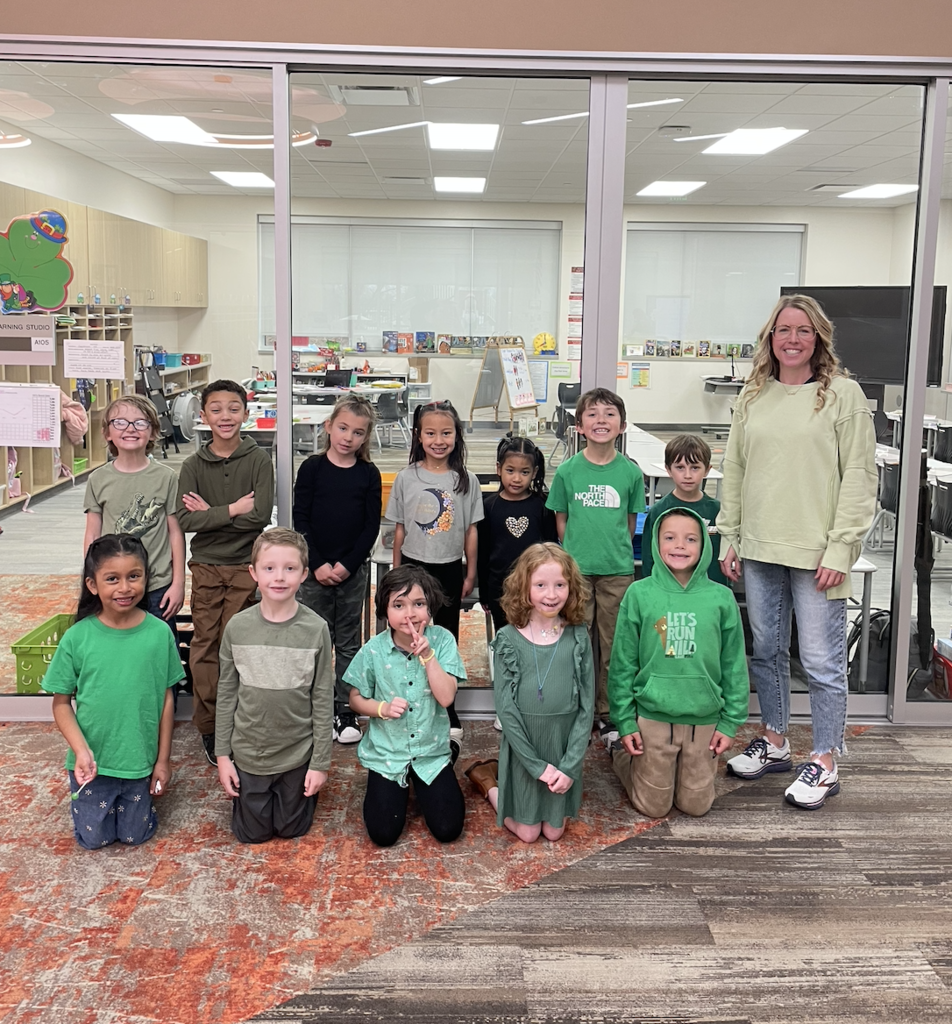 first grade class all smiling and wearing green in support of St. Patrick's Day