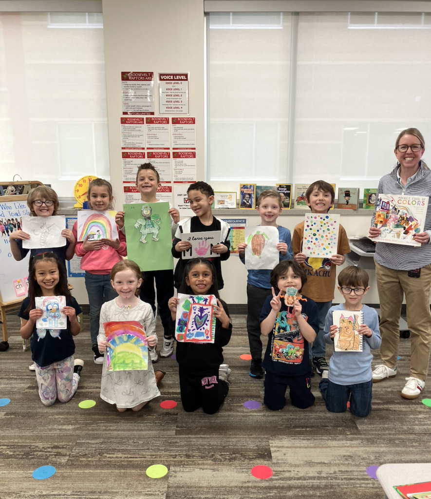students all holding their individual artwork that they created with their teacher