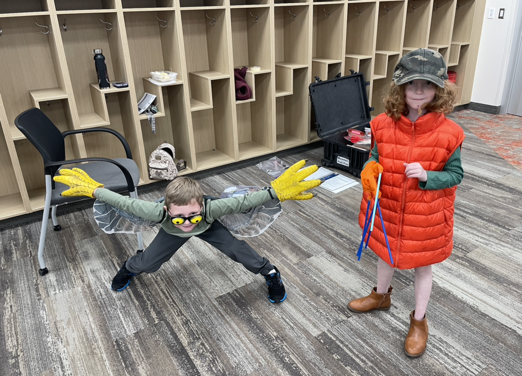 two students dressed up as birds as they learn about bird adaptations 