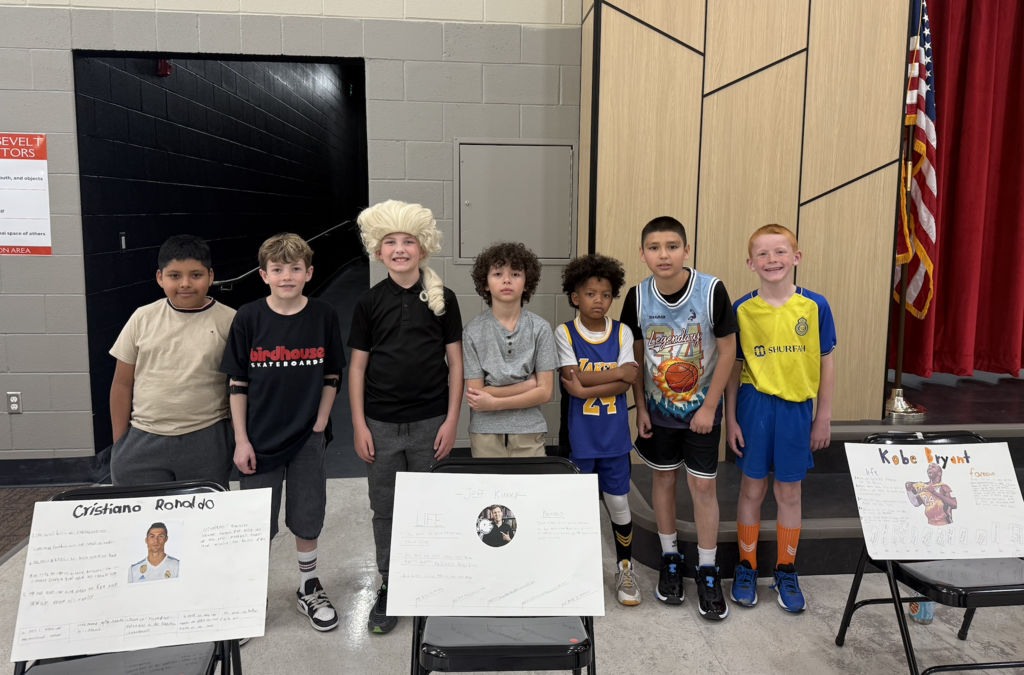 the 4th grade boys posing in the auditorium for the wax museum presentation 