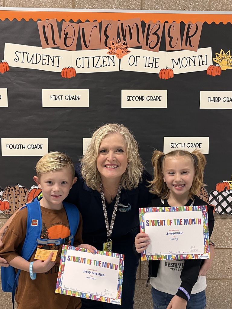 Photograph of student and citizen of the month award with teacher and students.