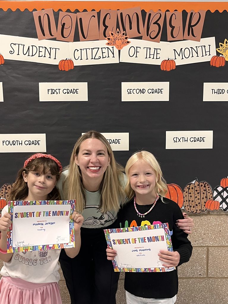 Photograph of student and citizen of the month award with teacher and students.