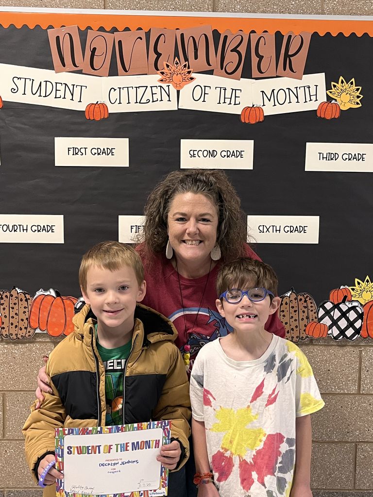 Photograph of student and citizen of the month award with teacher and students.