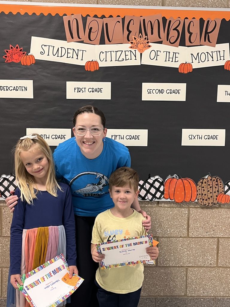Photograph of student and citizen of the month award with teacher and students.