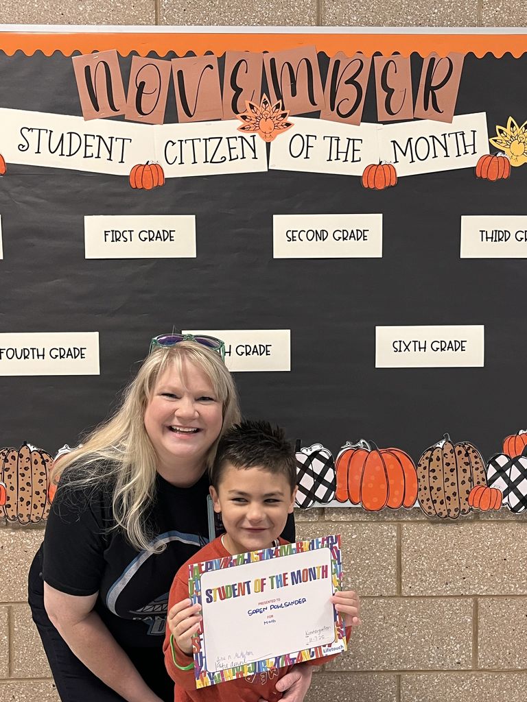Photograph of student and citizen of the month award with teacher and students.