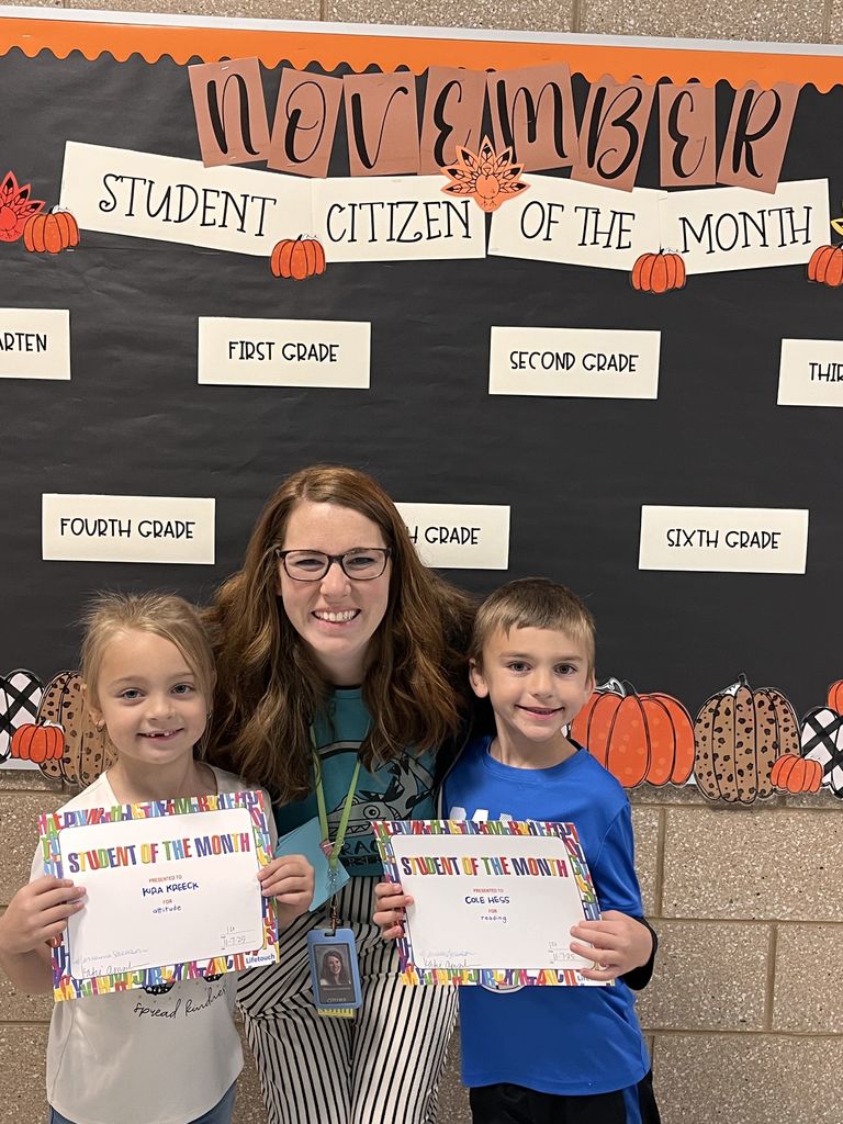 Photograph of student and citizen of the month award with teacher and students.
