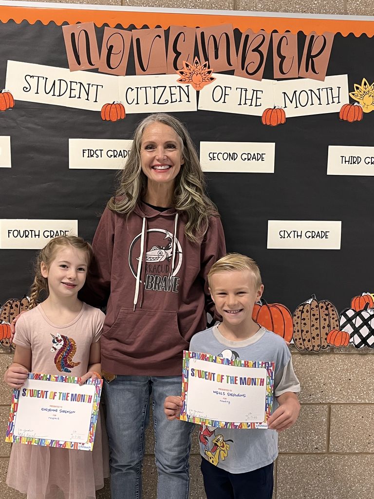 Photograph of student and citizen of the month award with teacher and students.