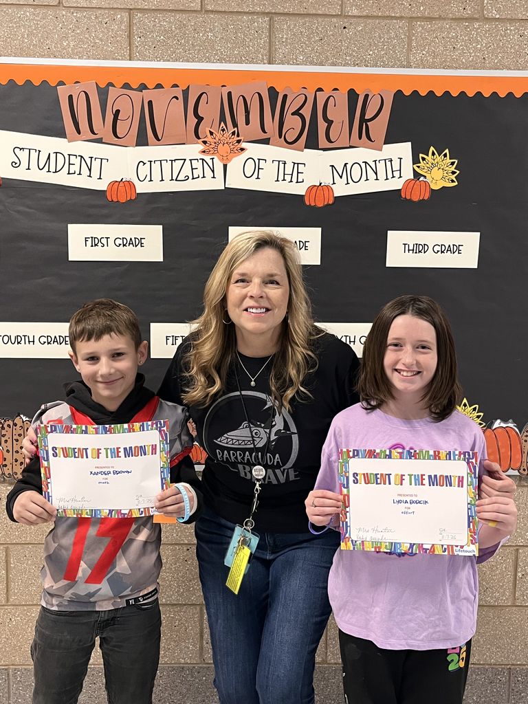 Photograph of student and citizen of the month award with teacher and students.