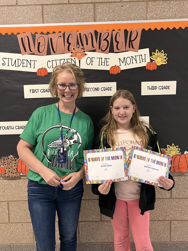 Photograph of student and citizen of the month award with teacher and students.