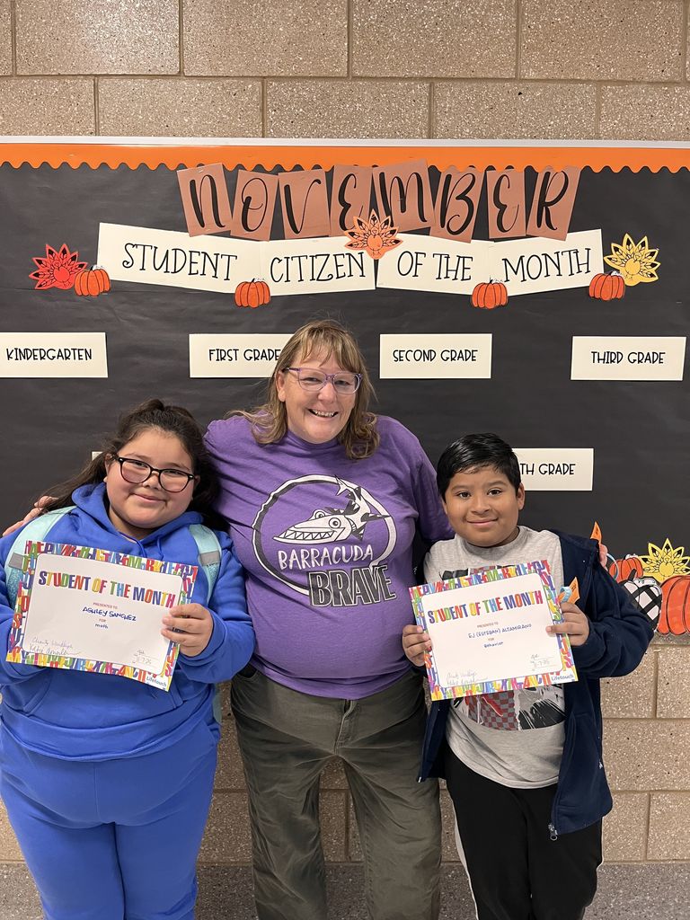 Photograph of student and citizen of the month award with teacher and students.