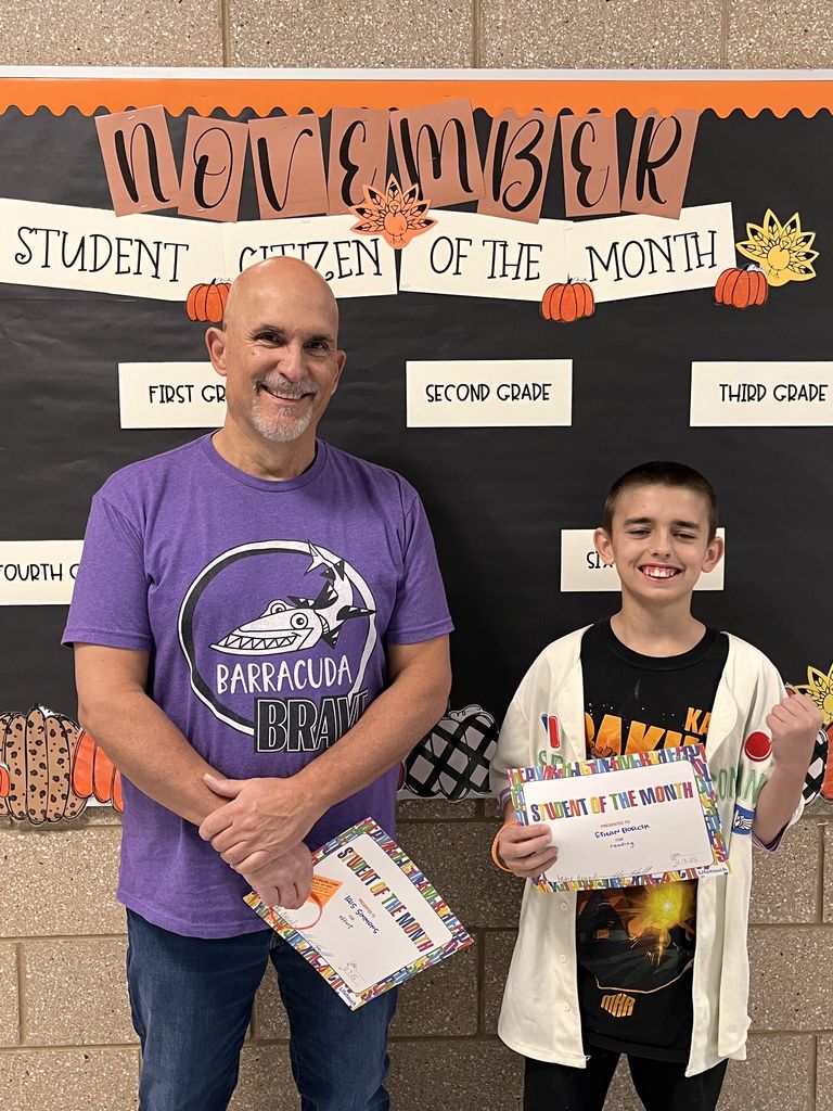 Photograph of student and citizen of the month award with teacher and students.