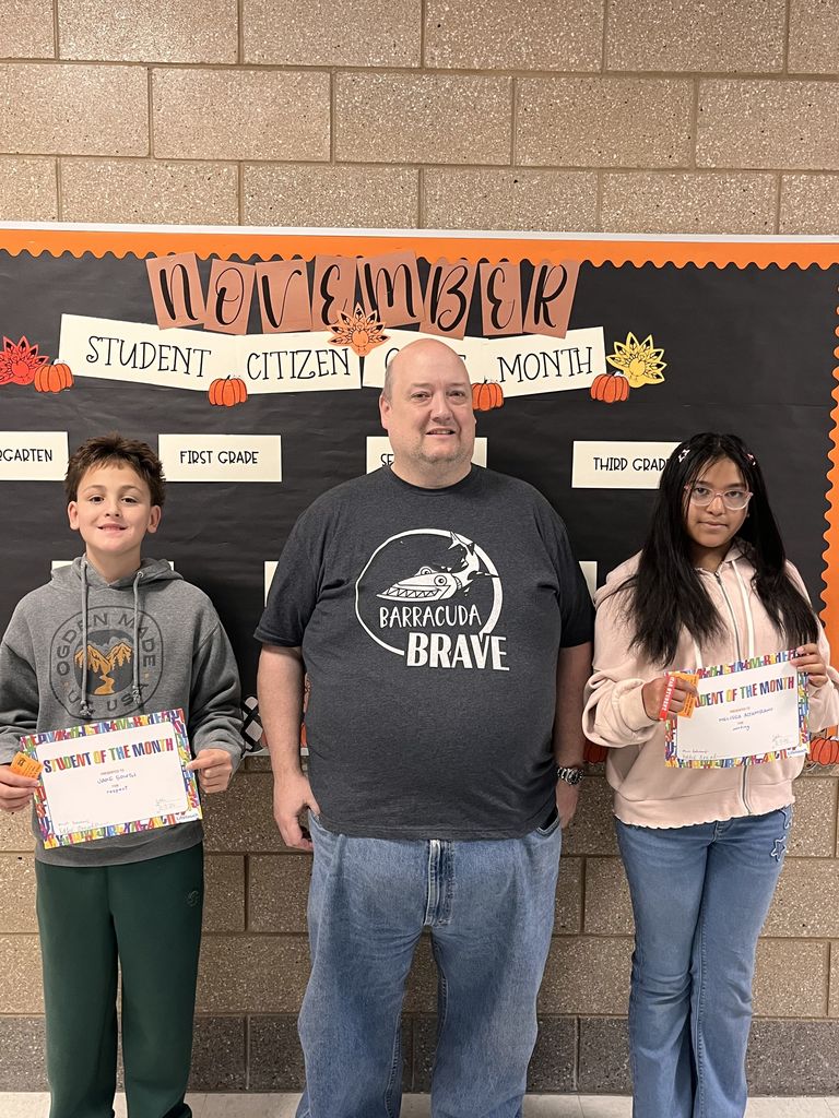 Photograph of student and citizen of the month award with teacher and students.