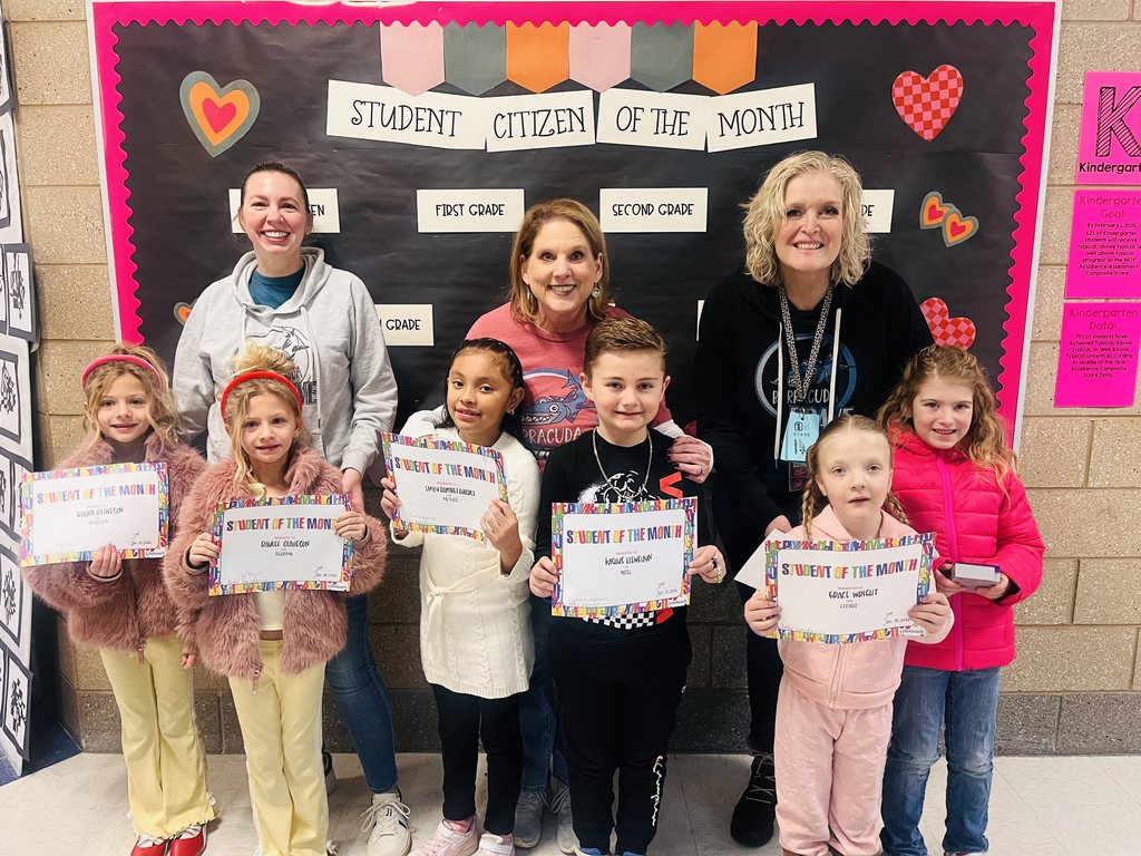 Photograph of student and citizen of the month award with teacher and students.