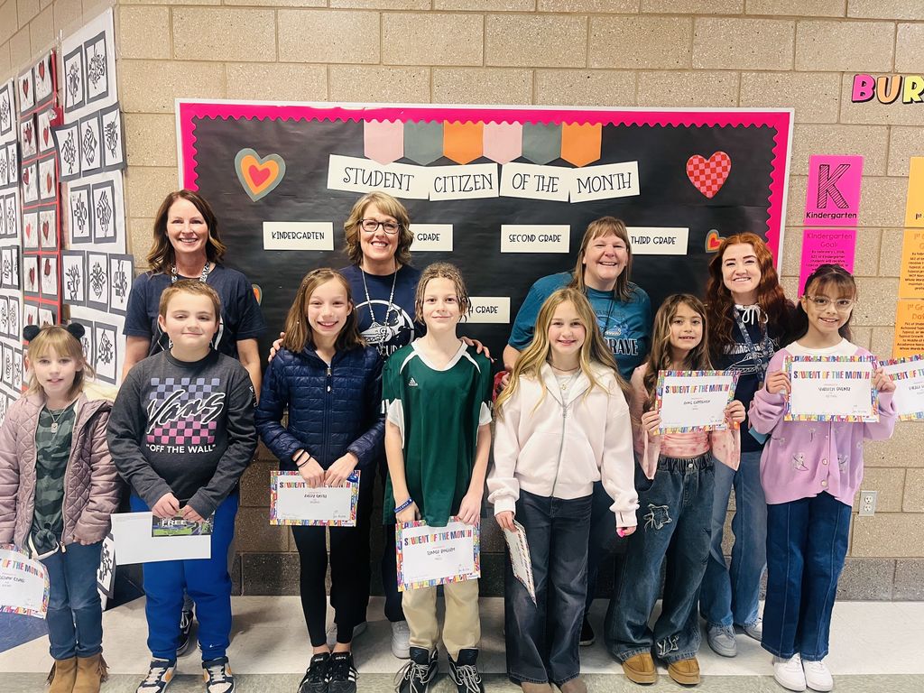 Photograph of student and citizen of the month award with teacher and students.